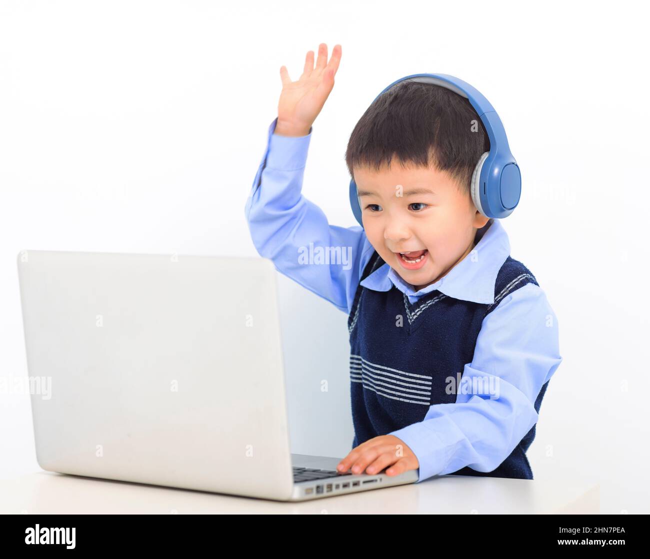 Happy kid boy doing homework project on laptop Stock Photo