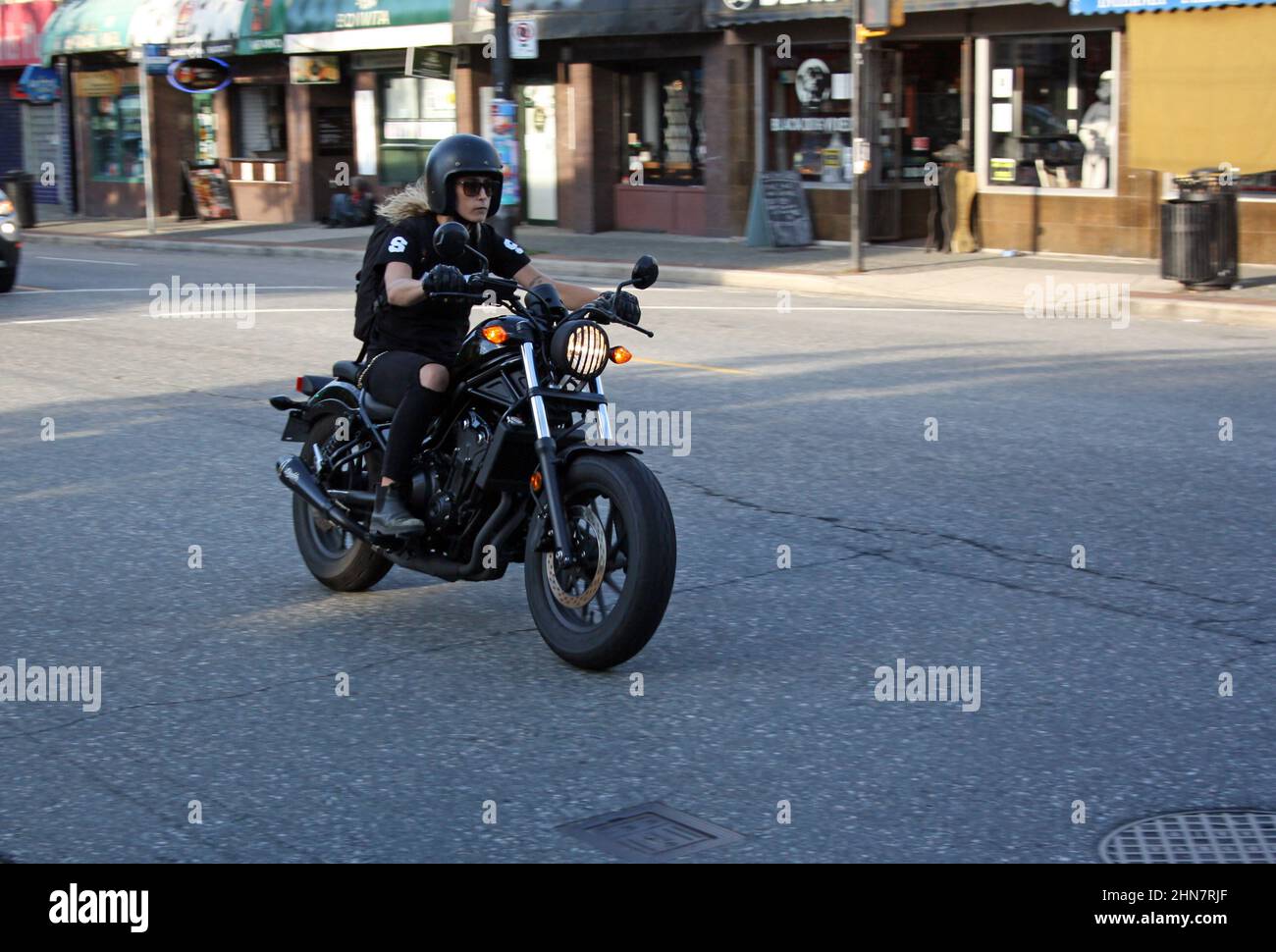 Female riding motorcycle in the street of Vancouver, British Columbia