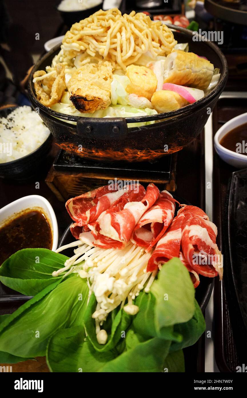 Japanese traditional hot pot Sukiyaki served with beef slices and