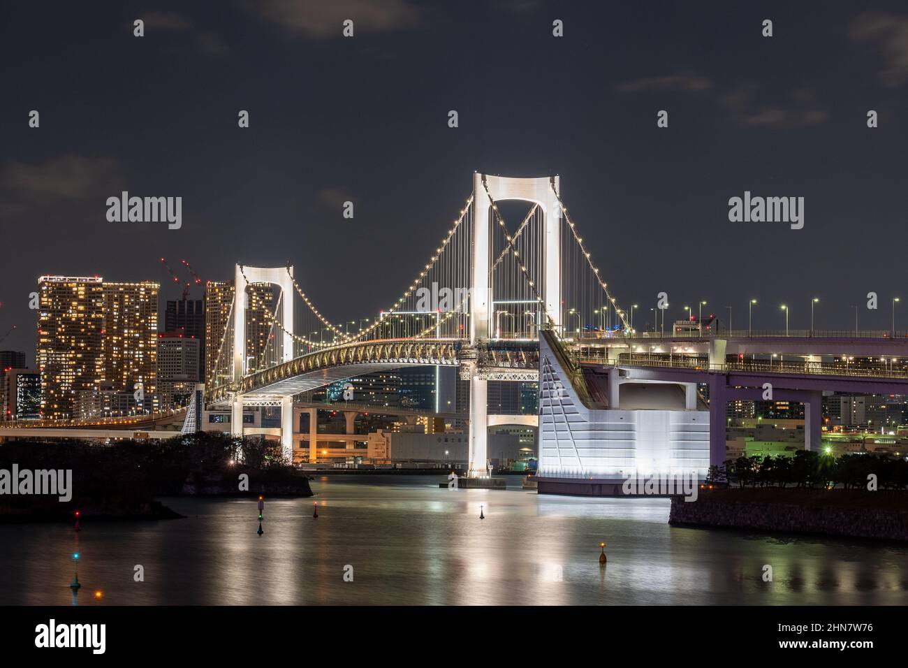 Rainbow bridge in Odaiba, with Tokyo city lights in the background Stock Photo