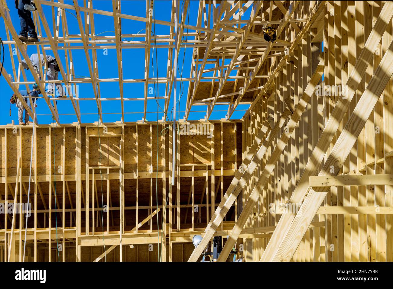 Installation of frame trusses joining with wooden beams at construction