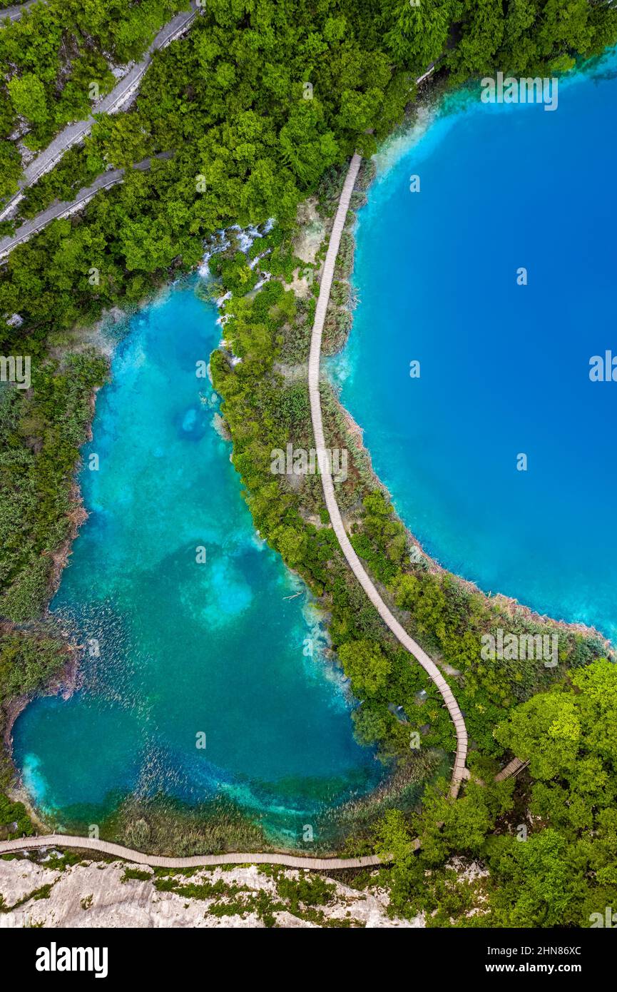 Plitvice, Croatia - Wooden walkway in Plitvice Lakes National Park on a bright summer day with crystal clear turquoise water, small waterfalls and gre Stock Photo