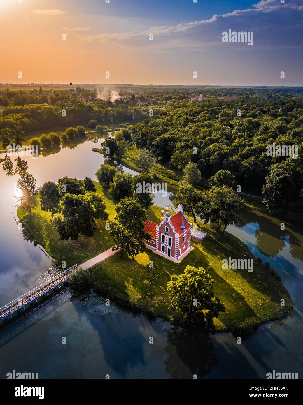 Deg, Hungary - Aerial panoramic view about the beautiful Holland house (Hollandi haz) on a small island at the village of Deg on a summer sunrise with Stock Photo