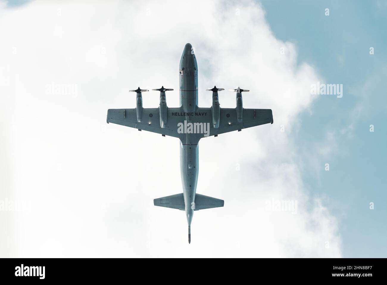 Huge military transport plane of Hellenic Navy or bomber with propellers view from below. The concept of air clashes and armed conflicts in Greece Stock Photo
