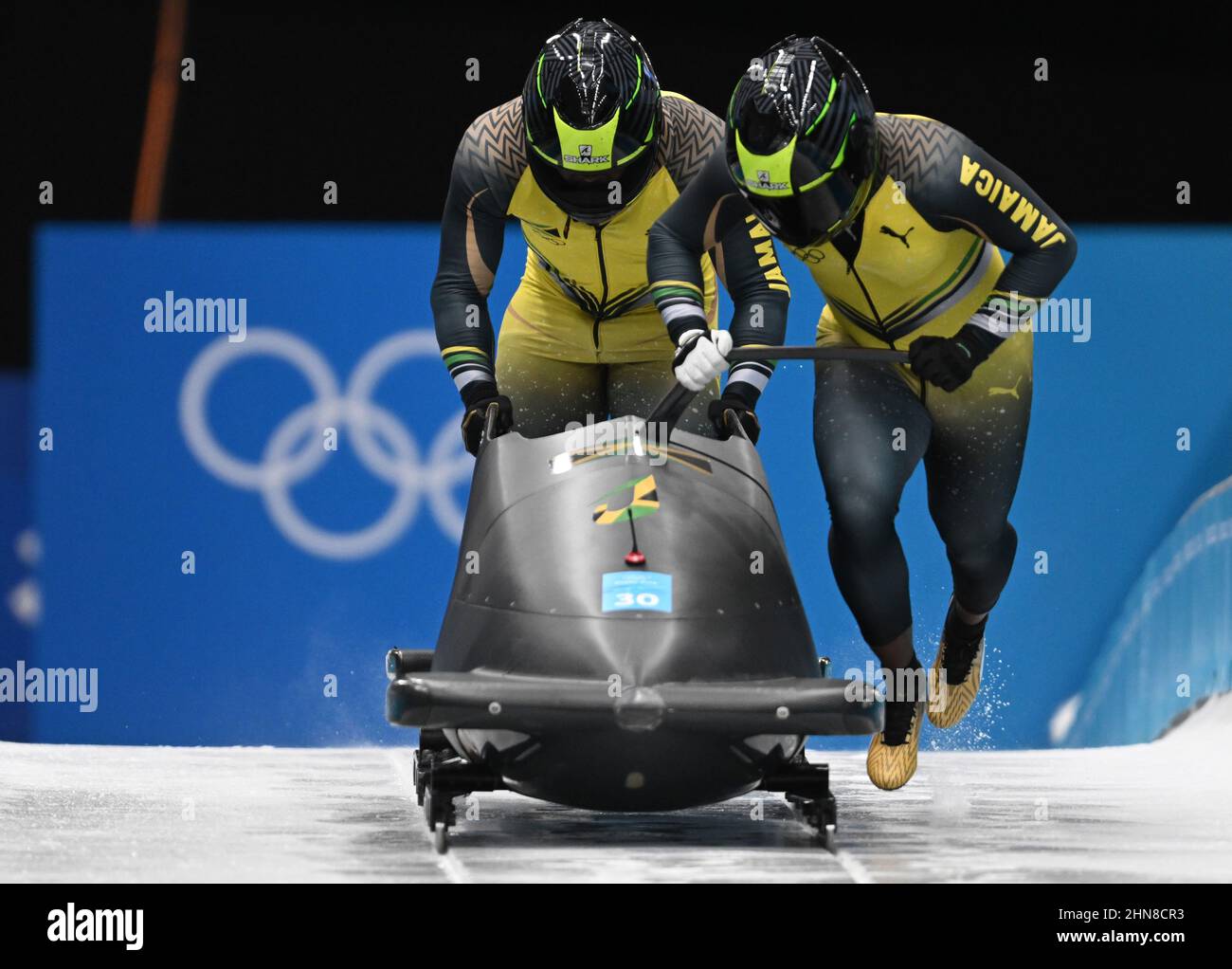Yanqing, China. 14th Feb, 2022. Olympics, bobsleigh, two-man bobsleigh, men, 1st run at the National Sliding Centre, bobsleigh pilot Shanwayne Stephens (r) and his pusher Nimroy Turgott from Jamaica start. Credit: Robert Michael/dpa-Zentralbild/dpa/17�Թ����� Live News Stock Photo