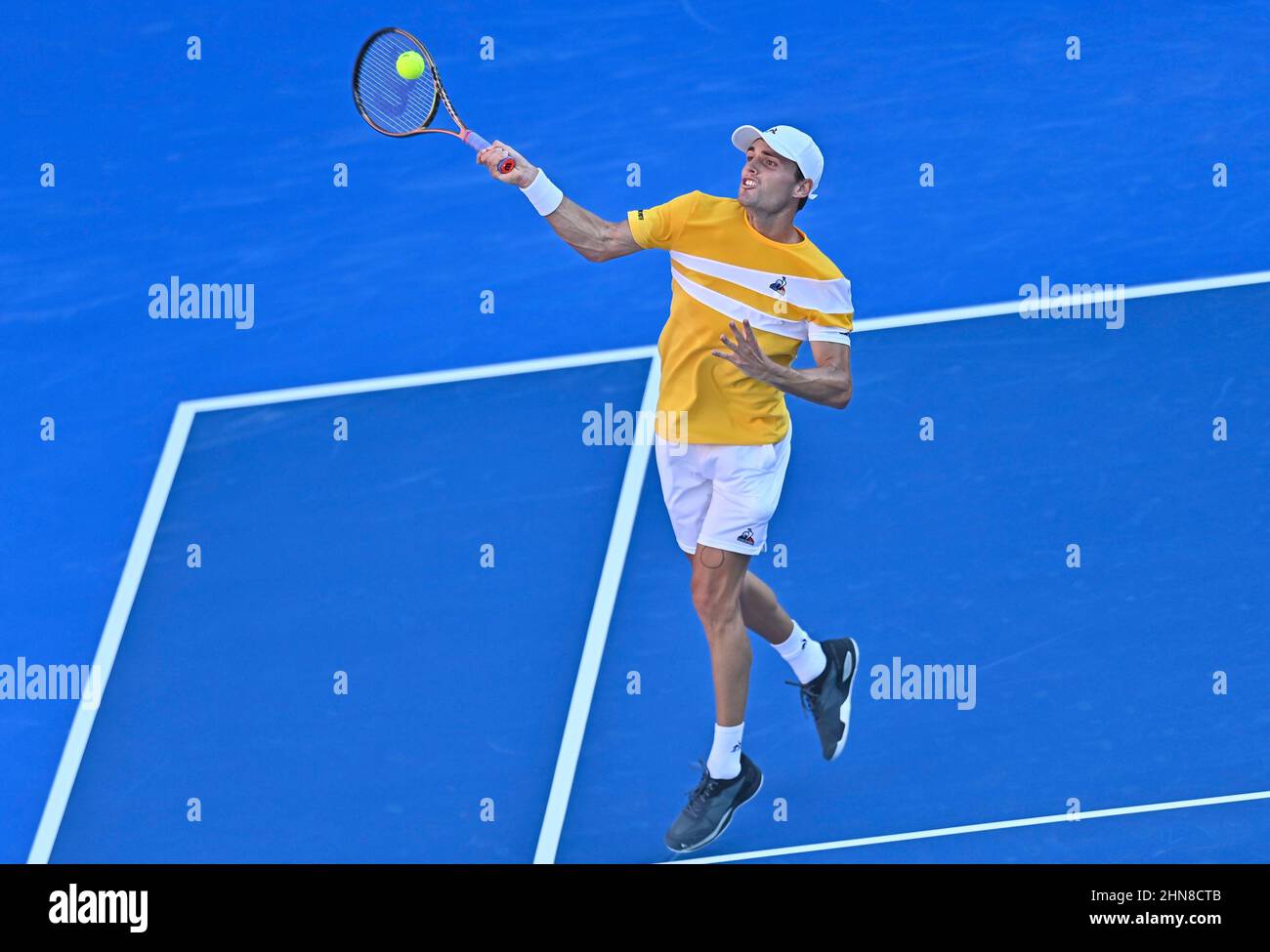 Doha, Qatar. 14th Feb, 2022. Christopher O'Connell of Australia returns the  ball to Alex Molcan of Slovakia during the first round of ATP Qatar Open  tennis match in Doha, capital of Qatar,