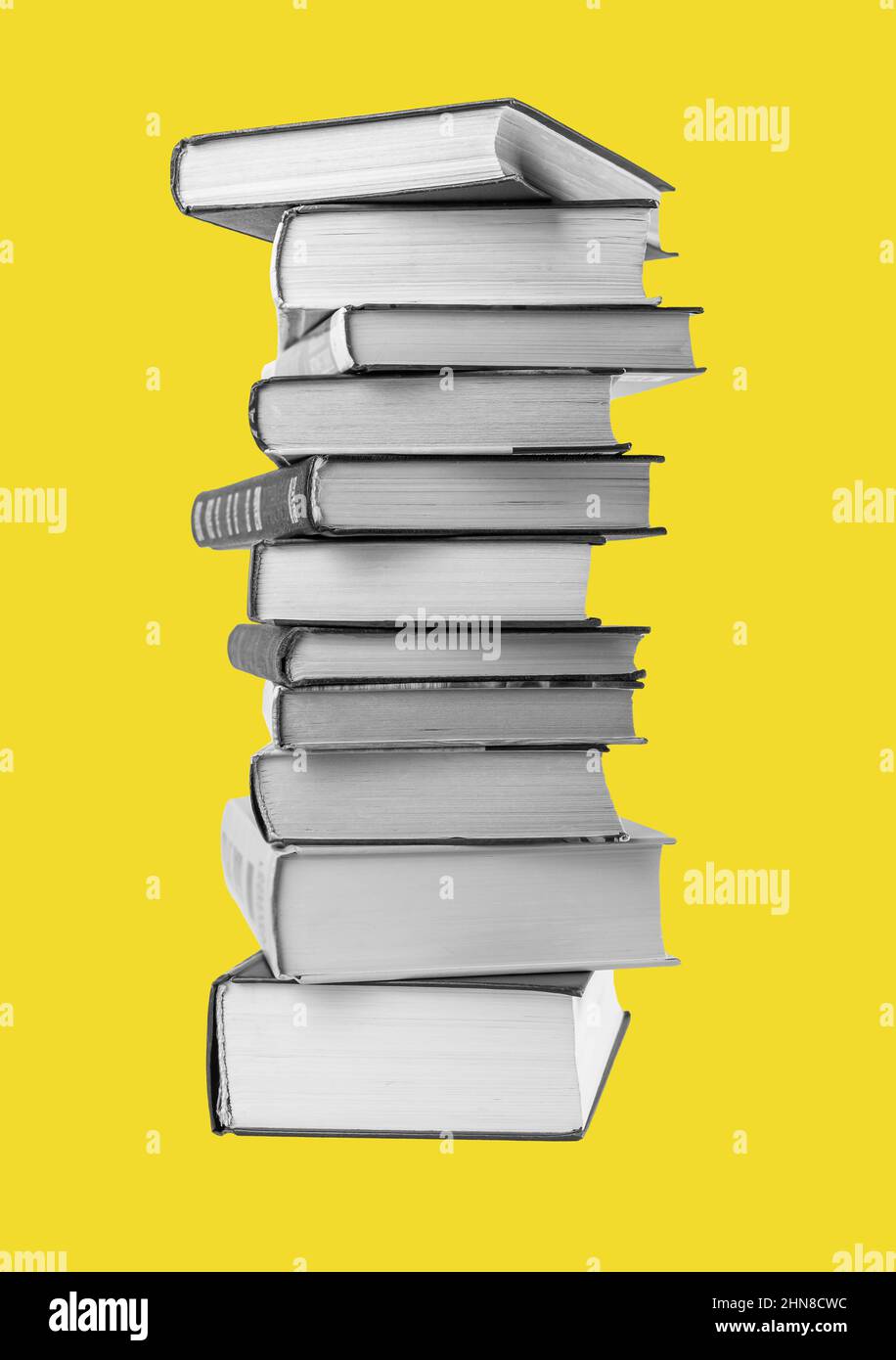 Big books pile at yellow background. Education, reading literature