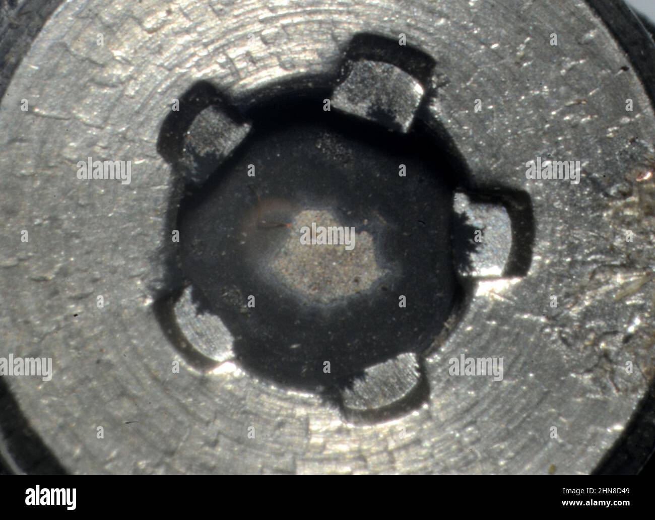 Microphoto of Americium source from old smoke alarm. Some micrograms of the radioactive isotope Americium 241 are deposited on a host metal in the cen Stock Photo