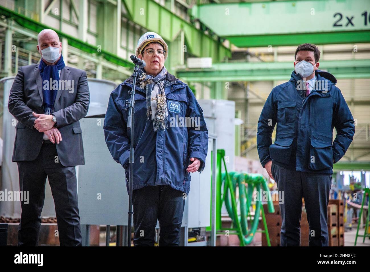 Wismar, Germany. 14th Feb, 2022. Ines Scheel, MV Werften works council member, Carsten Haake, (l) managing director of MV Werften, and Christoph Morgen (r), MV Werften's provisional insolvency administrator, in a pre-assembly hall at the insolvent MV Werft shipyard. Habeck visits the insolvent MV Werften Group and the hydrogen energy company Apex in Rostock-Laage after a meeting with Meyer, head of the state government. Credit: Jens Büttner/dpa-Zentralbild/ZB/dpa/Alamy Live News Stock Photo