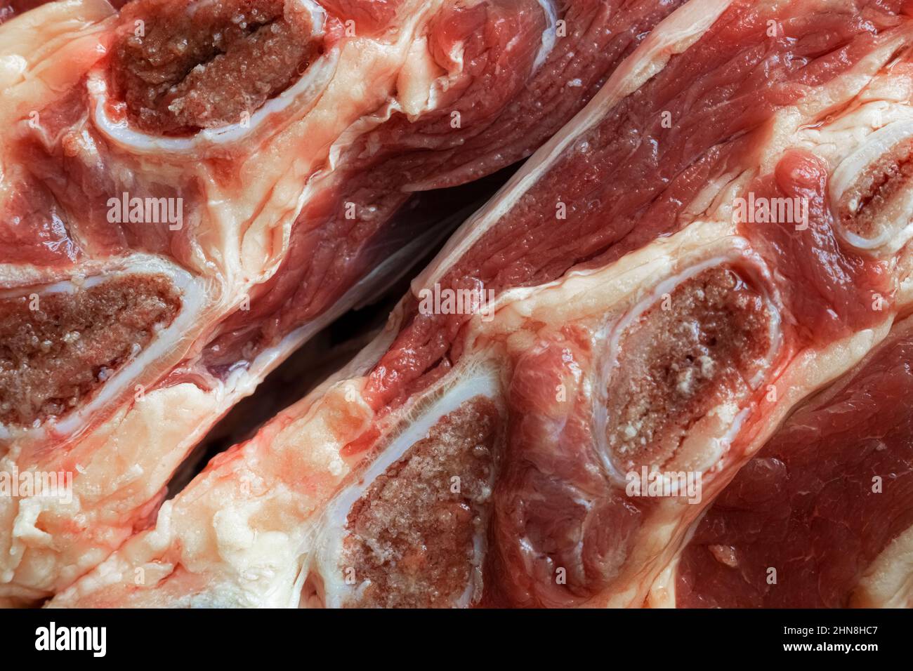 Diagonal shot of two pieces of beef with bones close-up Stock Photo
