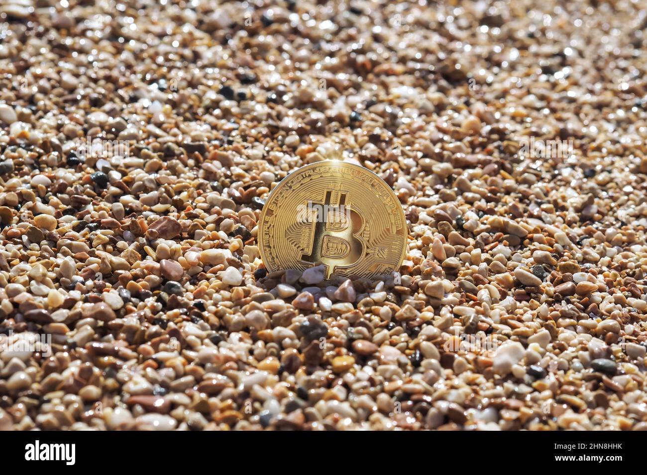 Bitcoin on a sandy beach Stock Photo - Alamy