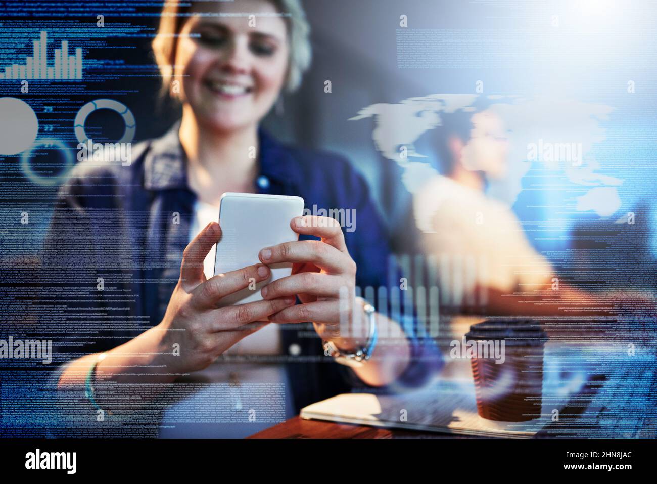 Running the code on her cellphone. Cropped shot of computer programmers working on new code. Stock Photo