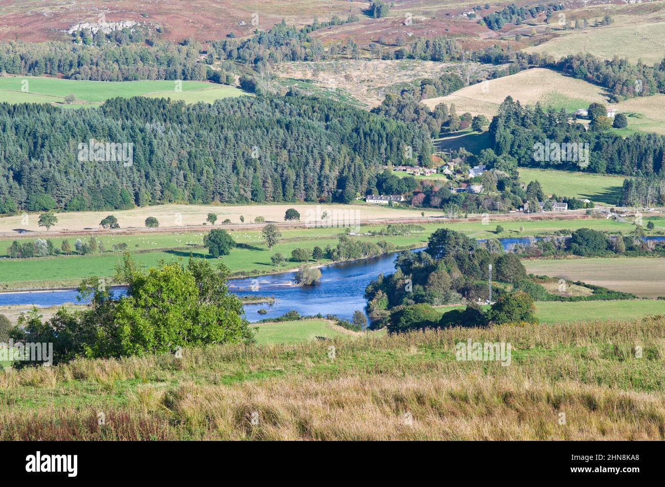 Looking down from Kinnaird to the River Tay and the picturesque hamlet of Guay on the opposite bank, sunny autumn afternoon, Perthshire, Scotland UK Stock Photo