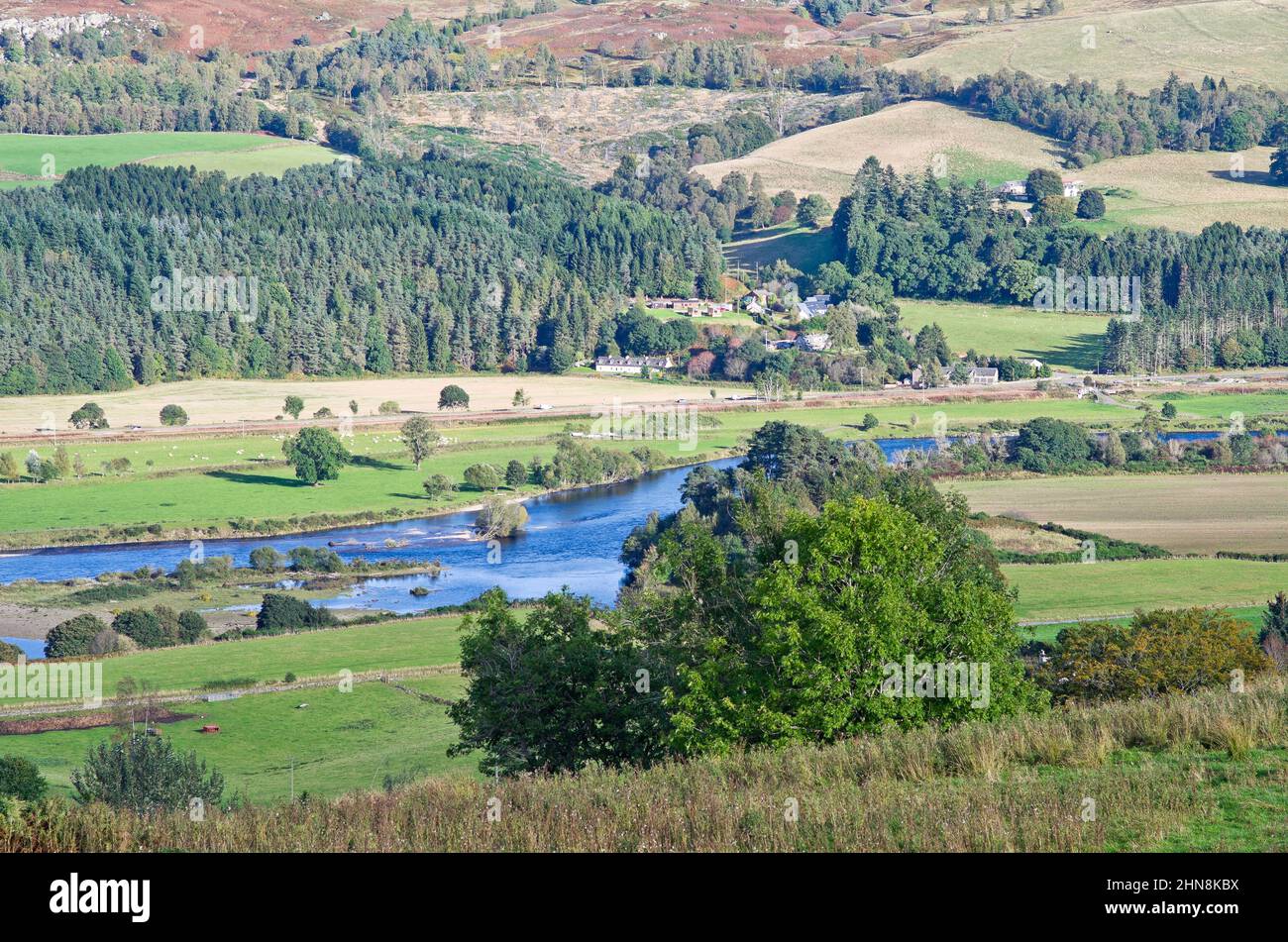 Looking down from Kinnaird to the River Tay and the picturesque hamlet of Guay on the opposite bank, sunny autumn afternoon, Perthshire, Scotland UK Stock Photo