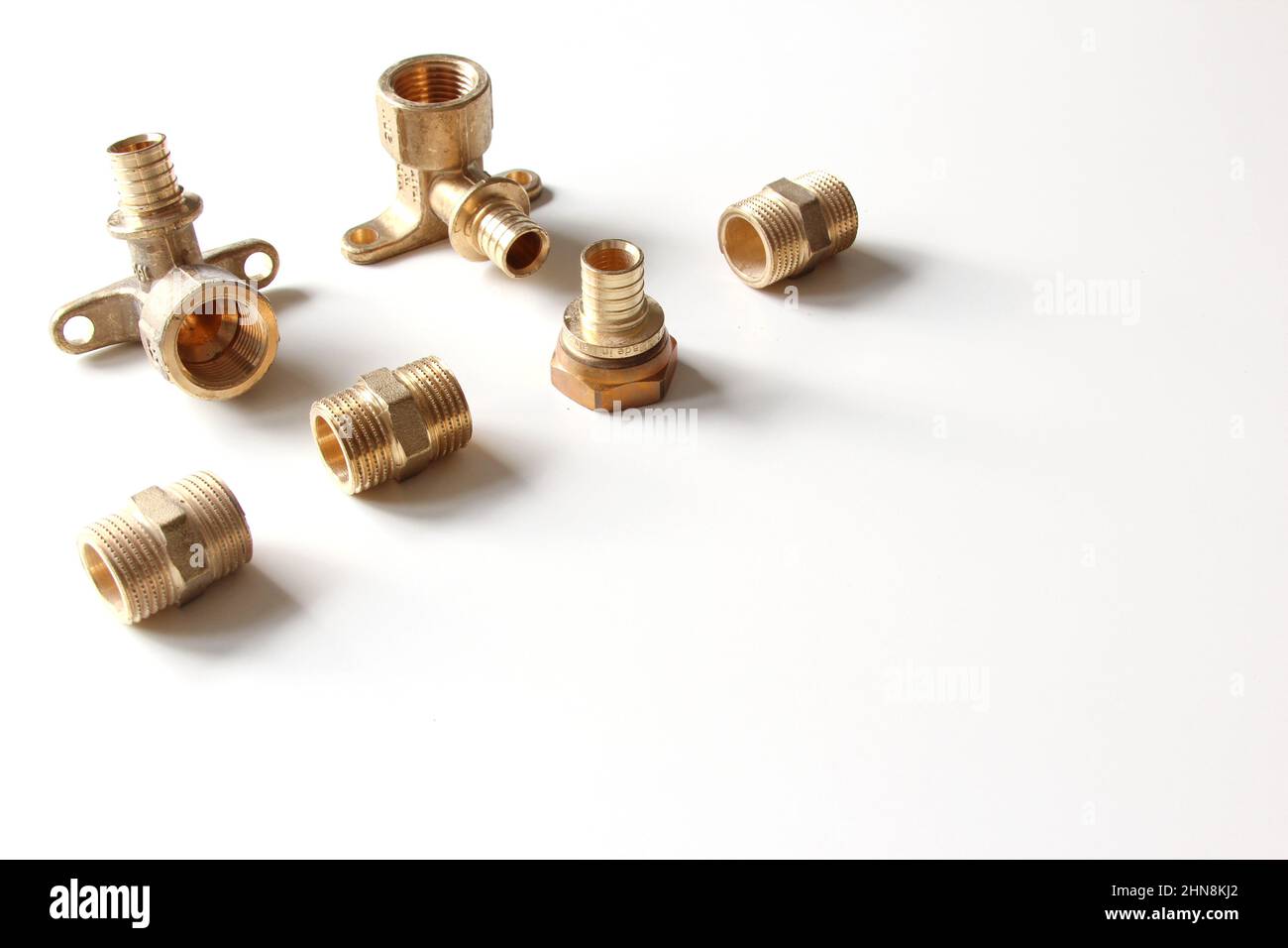 Plumbing faucet and brass fittings on the white background repairing or
