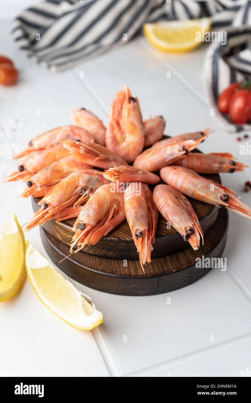 Thawed peeled shrimp, seafood, delicacy. on a white background, in a ...