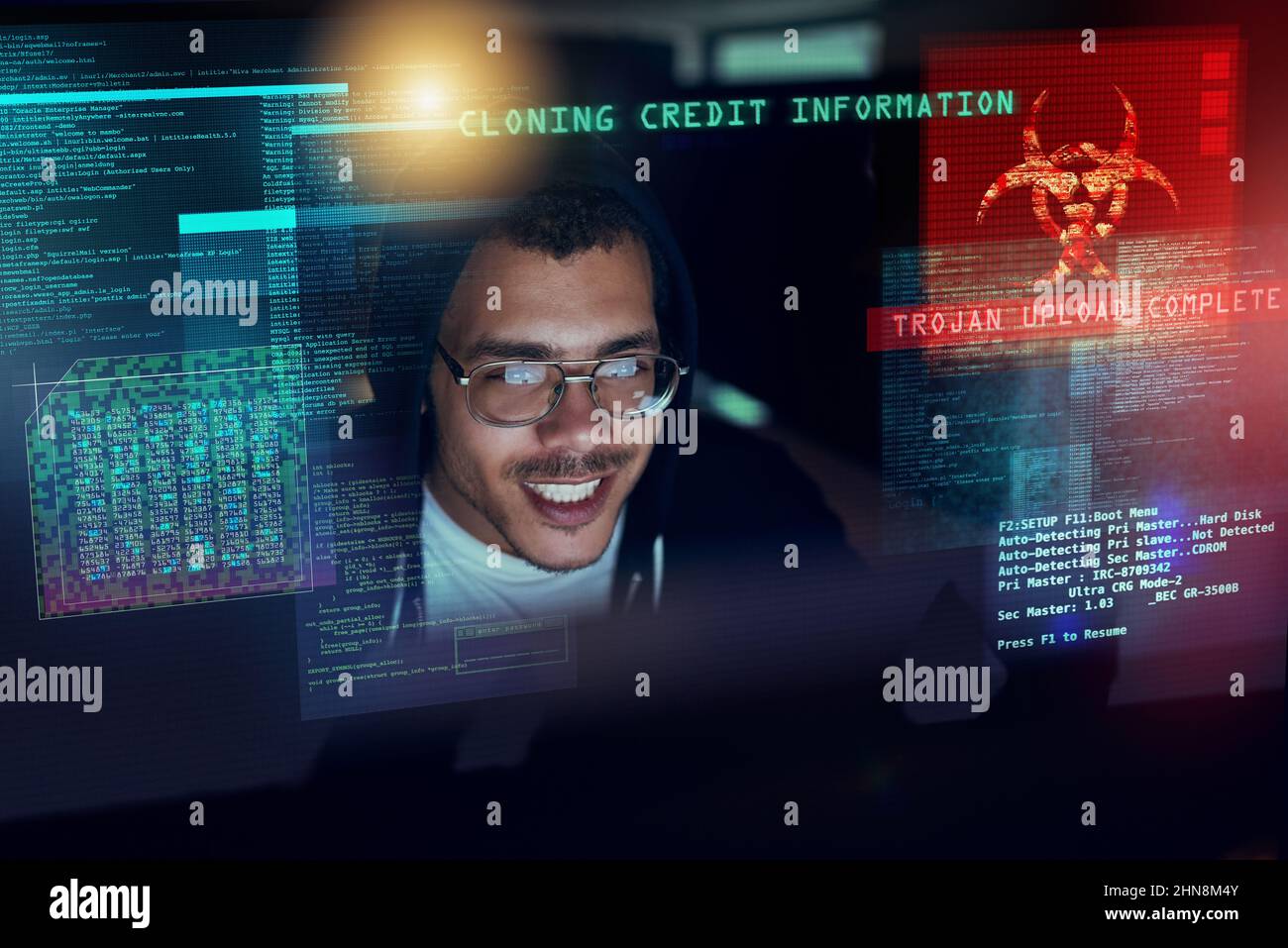 Its time to attack. Shot of a young hacker cracking a computer code in ...