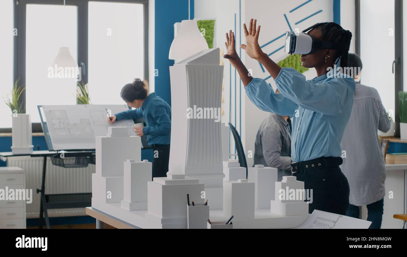 Engineer using vr glasses to design building model and construction for ...