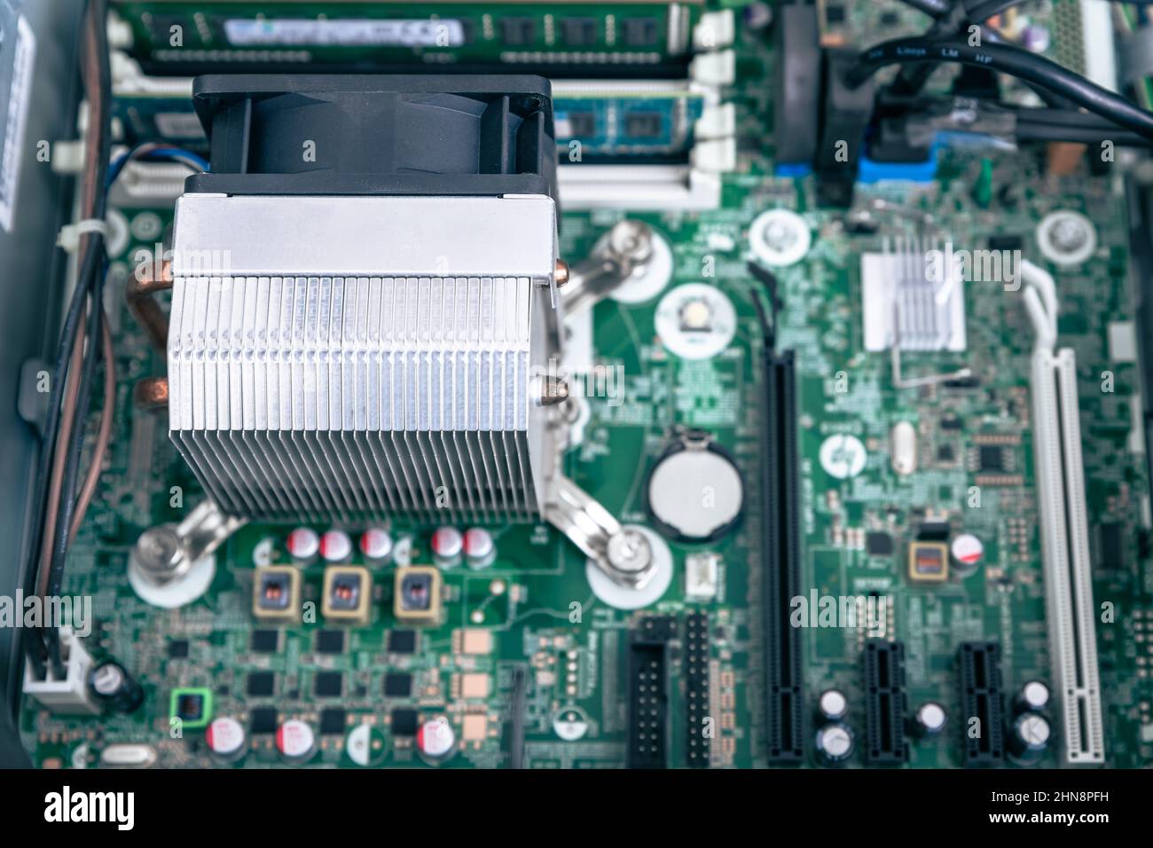 Woodville, Australia - October 15, 2021: Close-up top view of CPU cooler installed in business desktop PC motherboard Stock Photo