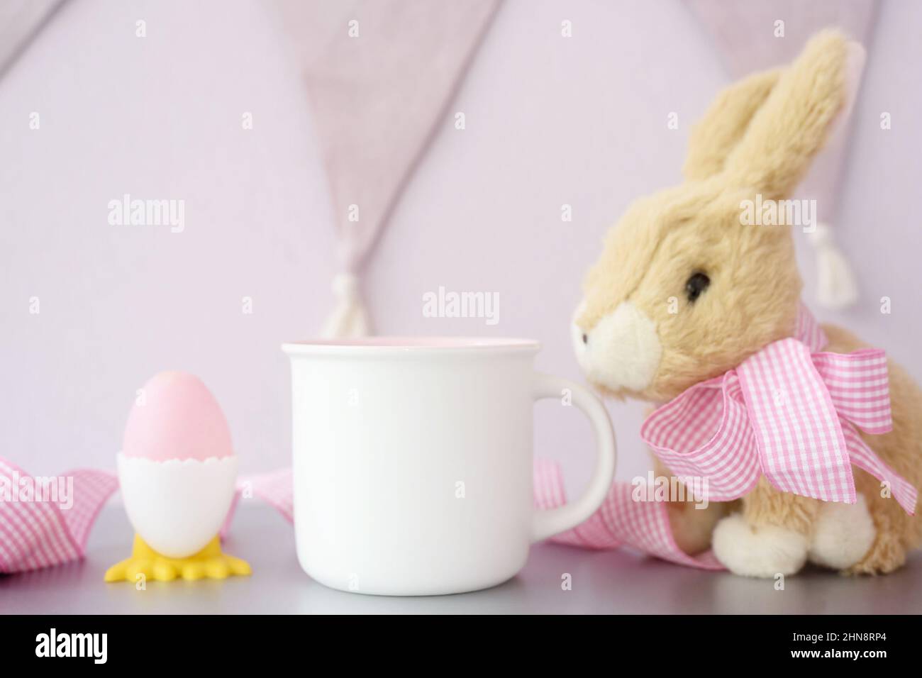 White coffee mug easter mockup with fur bunny Stock Photo