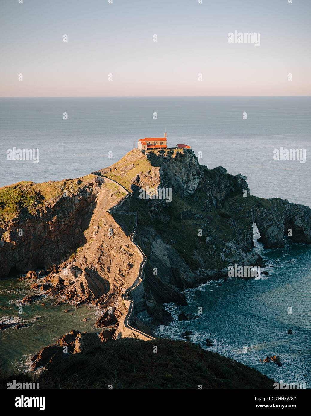 Vertical drone shot of a house placed on a huge cliff surrounded by ...