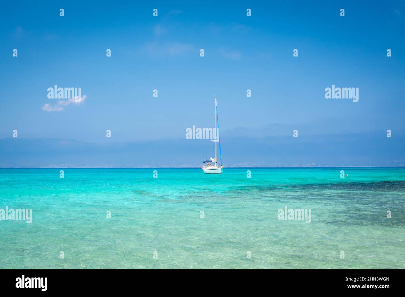 white sand,blue water,boat,beach ,Chrissi island.Greece Stock Photo