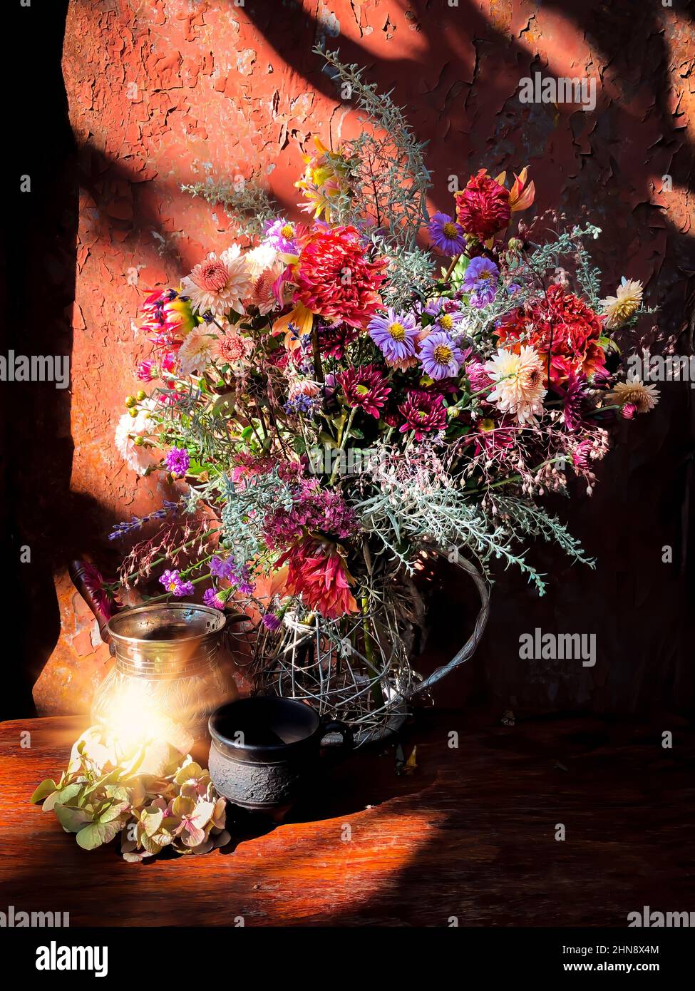Romantic bouquet with flowers of dahlia, chrysanthemum, perennial aster, montbrecia, geyhera, wormwood flowers and sedum with cezve and coffee cup in Stock Photo