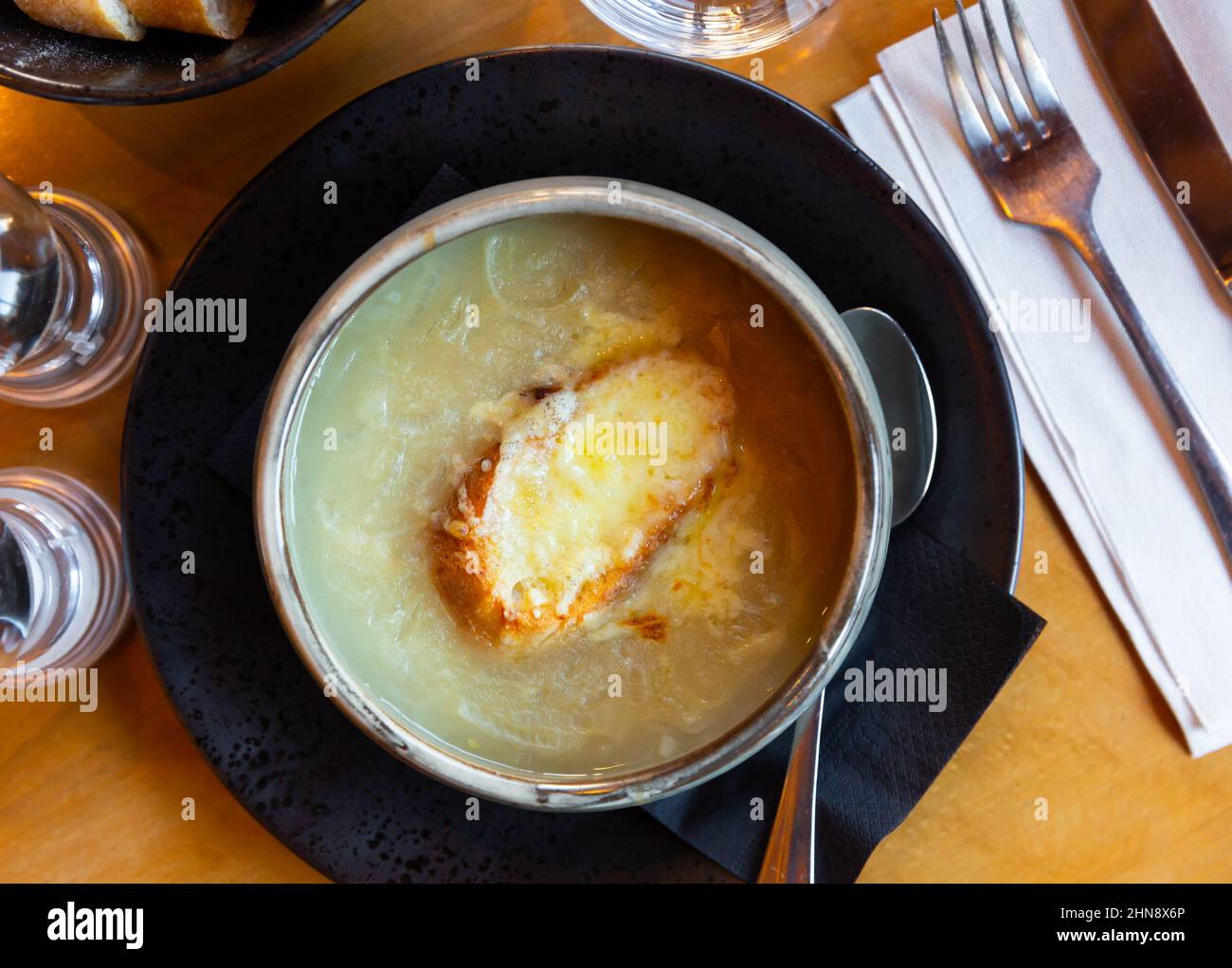 Gratin onion soup served with piece of crouton and cheese Stock Photo