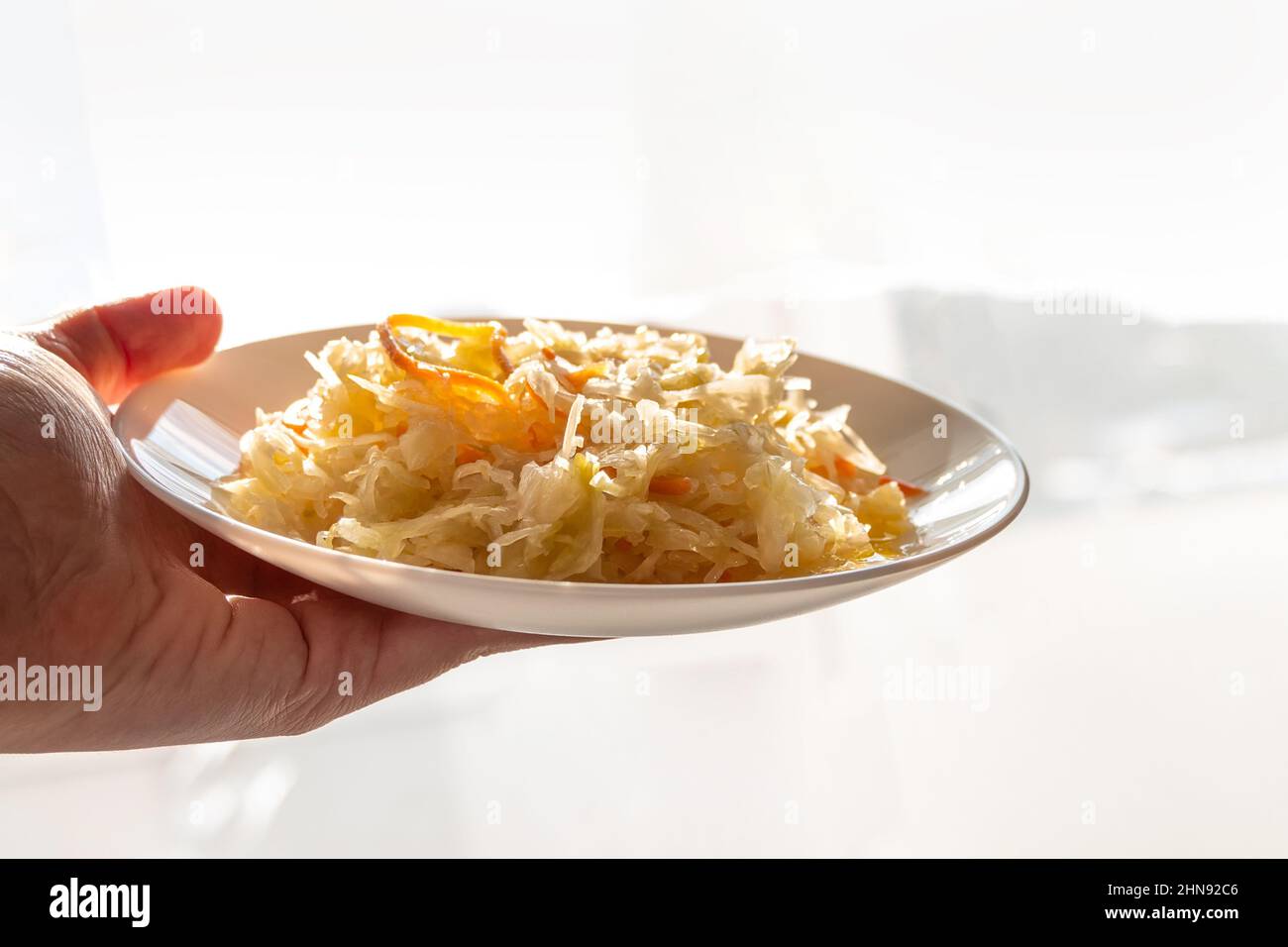 Sauerkraut with vegetable oil in rays of daylight. National european