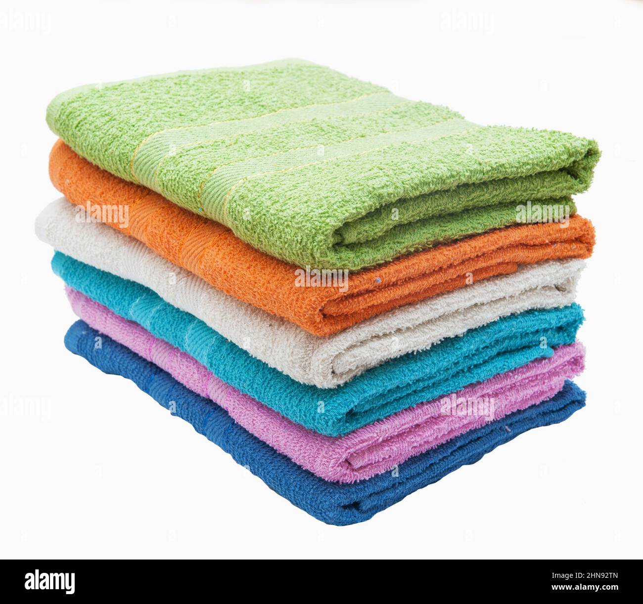 Stack of multi-colored terry towels on a white background Stock Photo