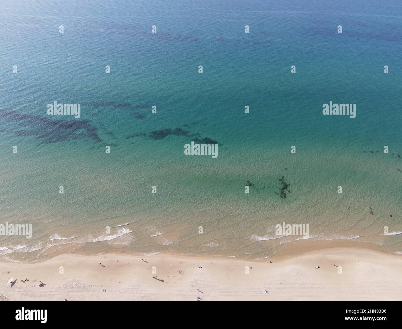 Aerial view of the coast and the ocean during the sunny day Stock Photo ...
