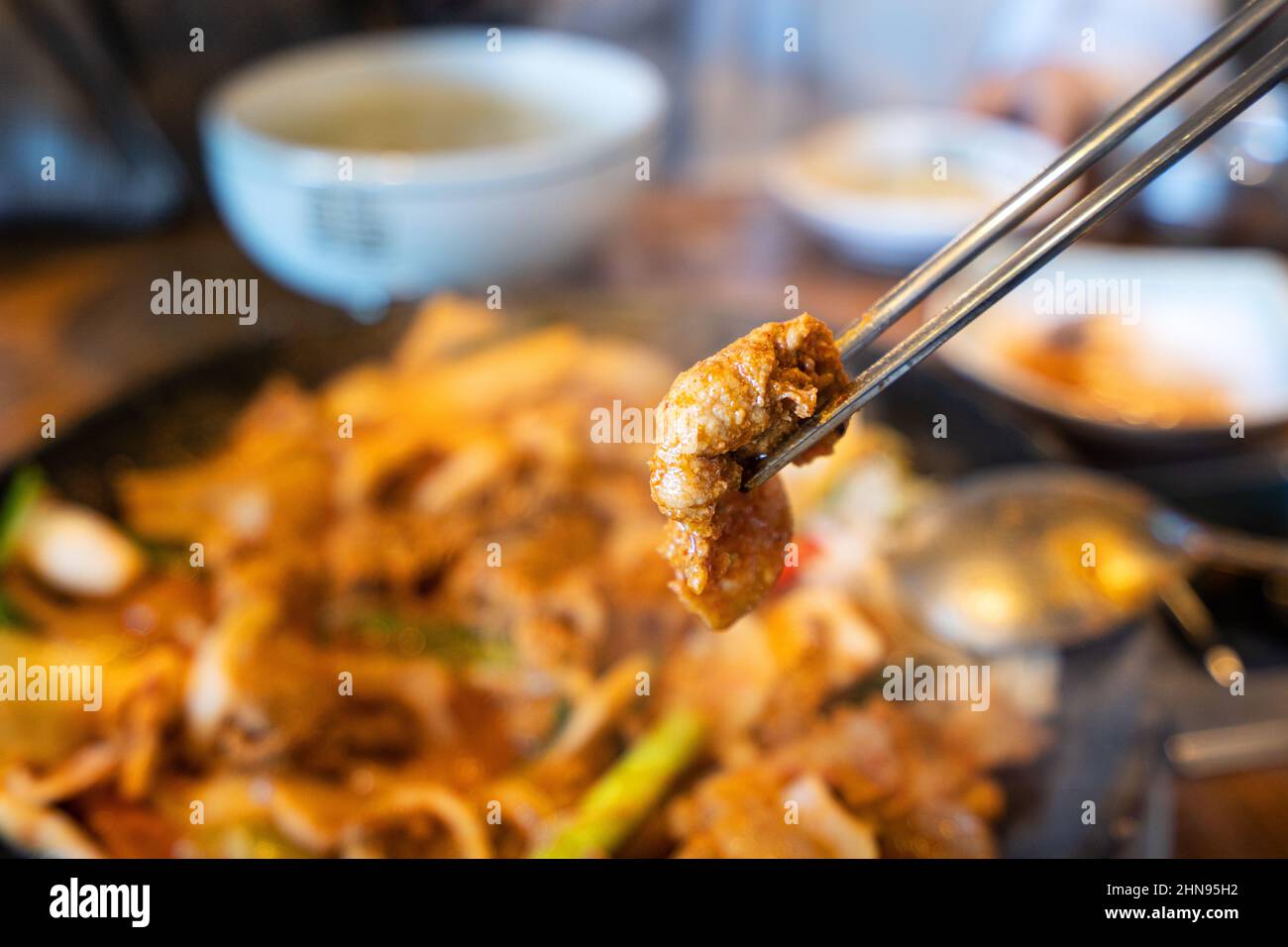 Close up of ssam Korean BBQ, pan-fried black pork with lettuce meal in Korea restaurant, fresh delicious korean cuisine. Stock Photo