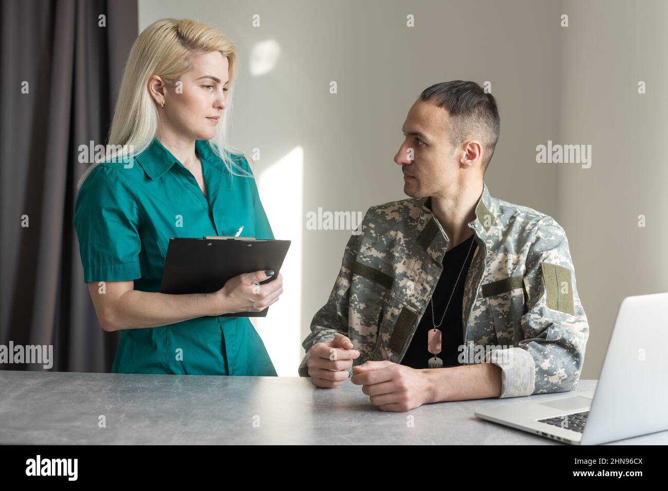 Soldier working with laptop in headquarters building Stock Photo - Alamy