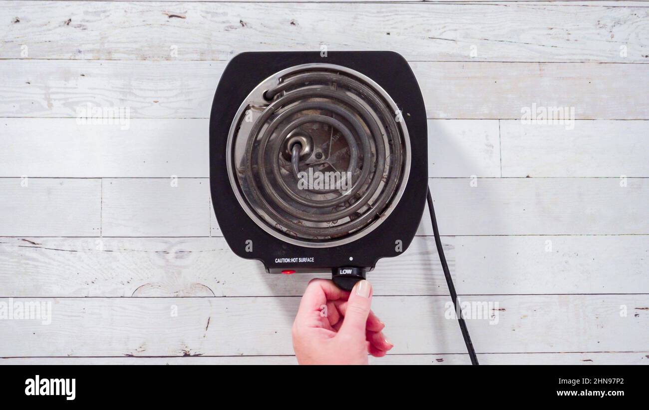 Flat lay. Portable one burner electric stove on the table Stock Photo