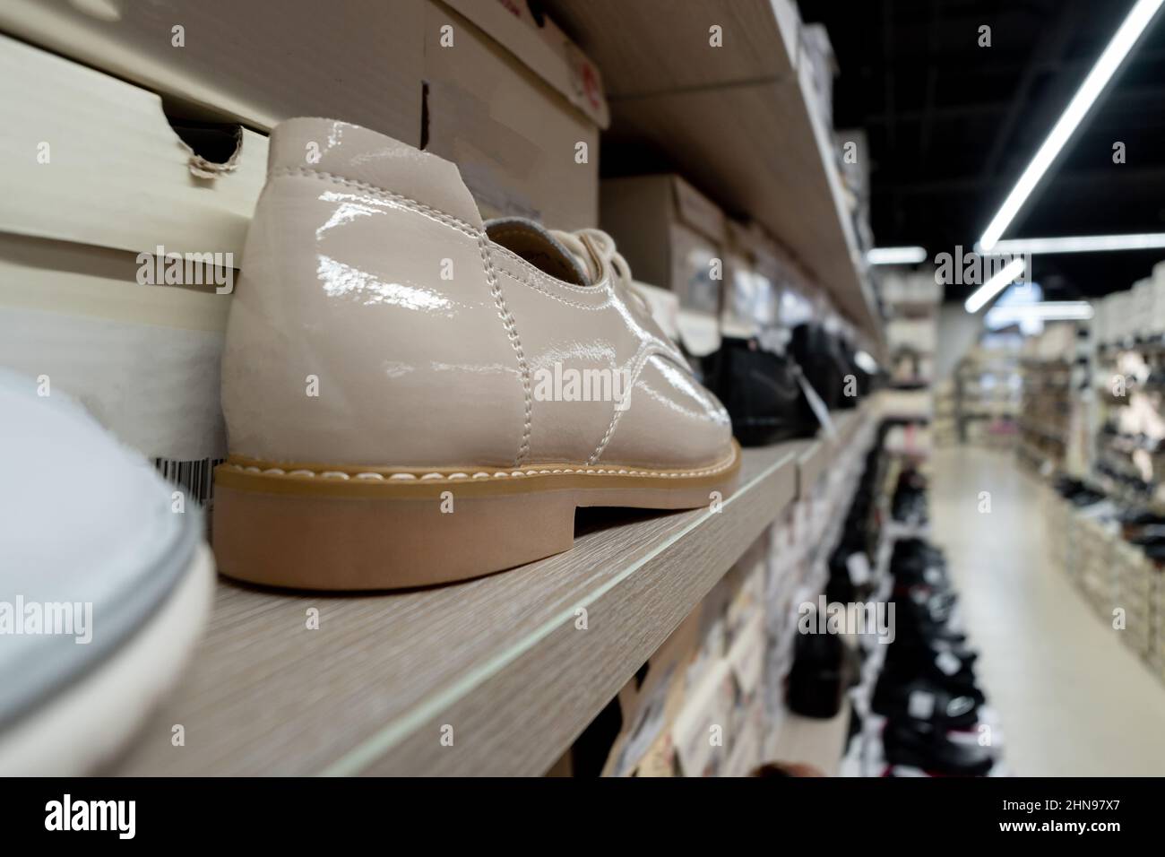 Patent leather shoes in the store. Shoes are in a row. Lots of shoes. Selective focus Stock Photo