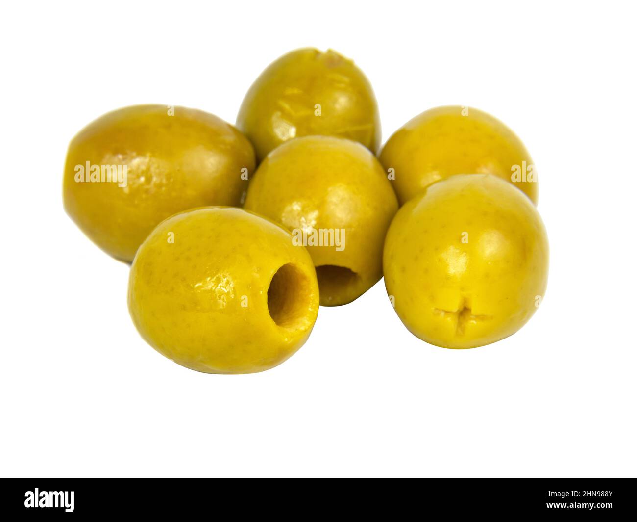 Many green olives pitted isolated on the white background Stock Photo