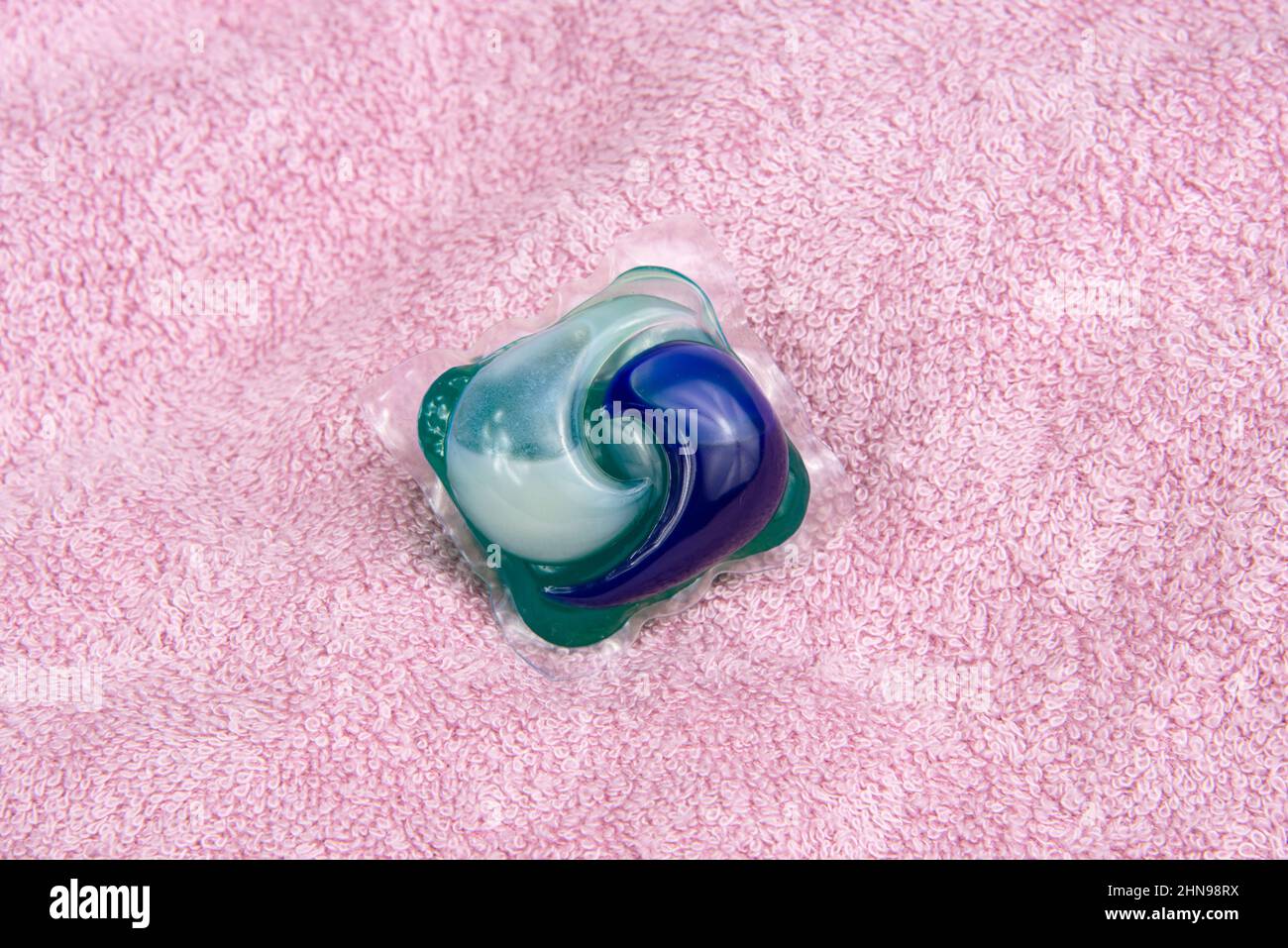Colorful gel capsule for washing on pink material soft background Stock