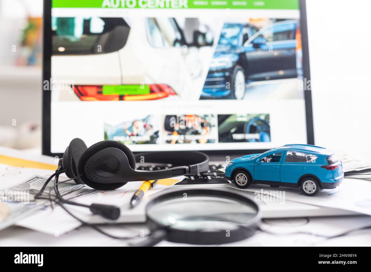 toy car with dollars is on the laptop. The programmer Stock Photo - Alamy