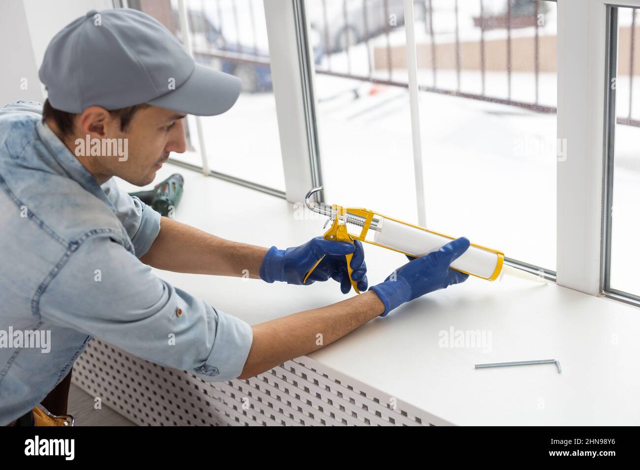 The worker installing and checking window in the house Stock Photo - Alamy