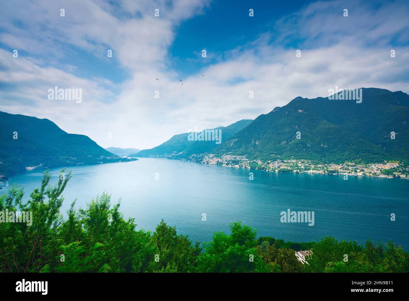 Como Lake landscape. Aerial view, trees, water and mountains. Italy, Europe. Stock Photo