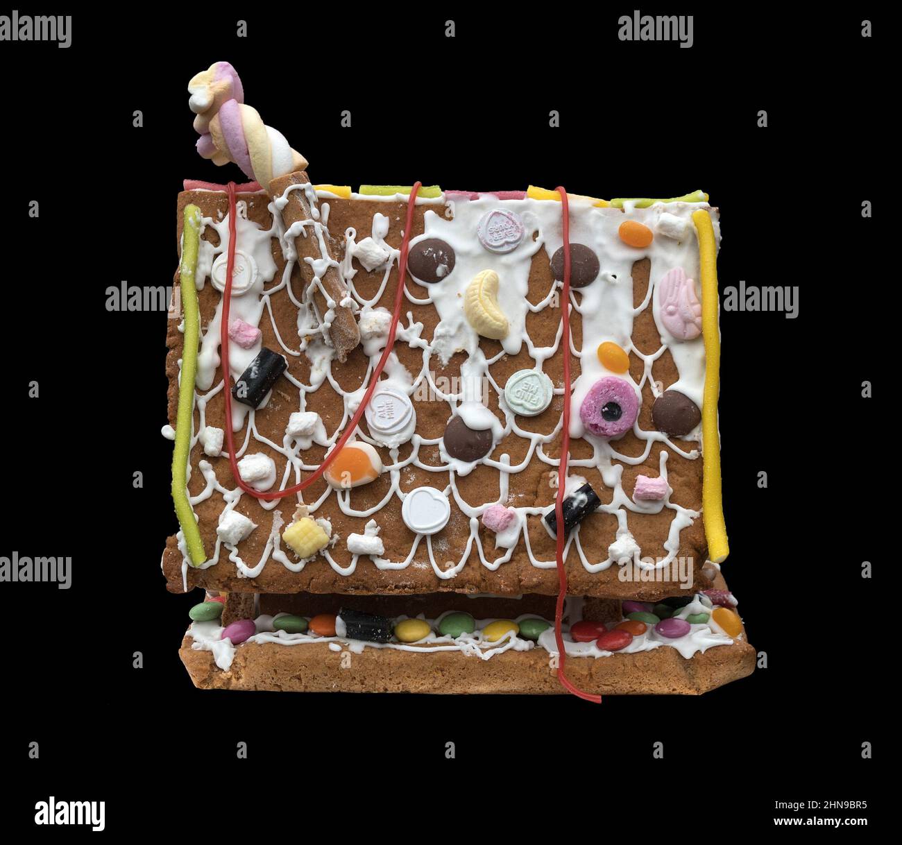 A Gingerbread house against a black background Stock Photo