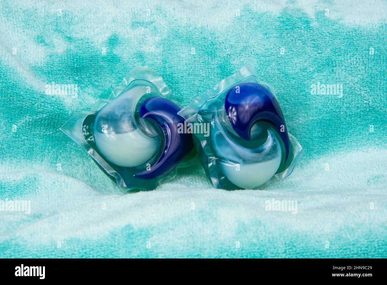 Colorful gel capsule for washing on blue green material soft background