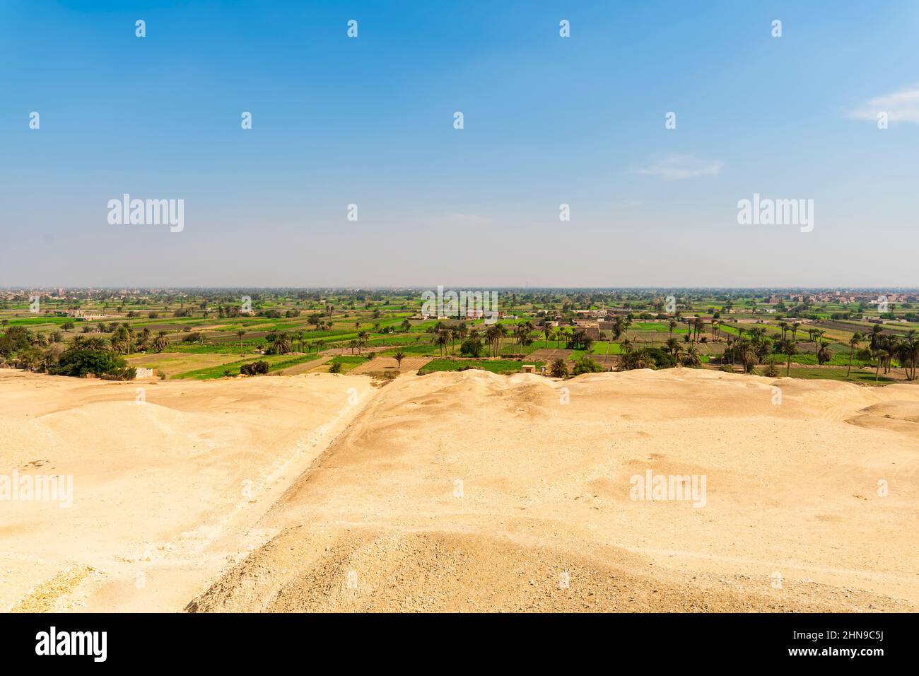 deserts are green areas with plants with a clear border. The concept of desertification of lands with a dry climate. mastering the desert Stock Photo