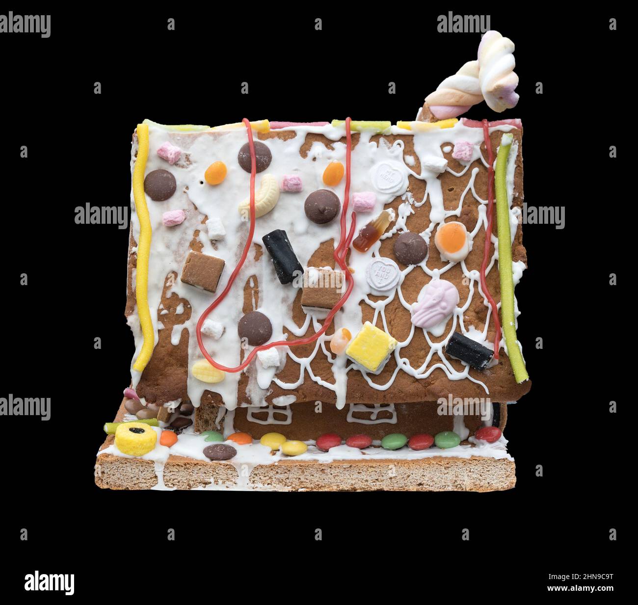 A Gingerbread house against a black background Stock Photo