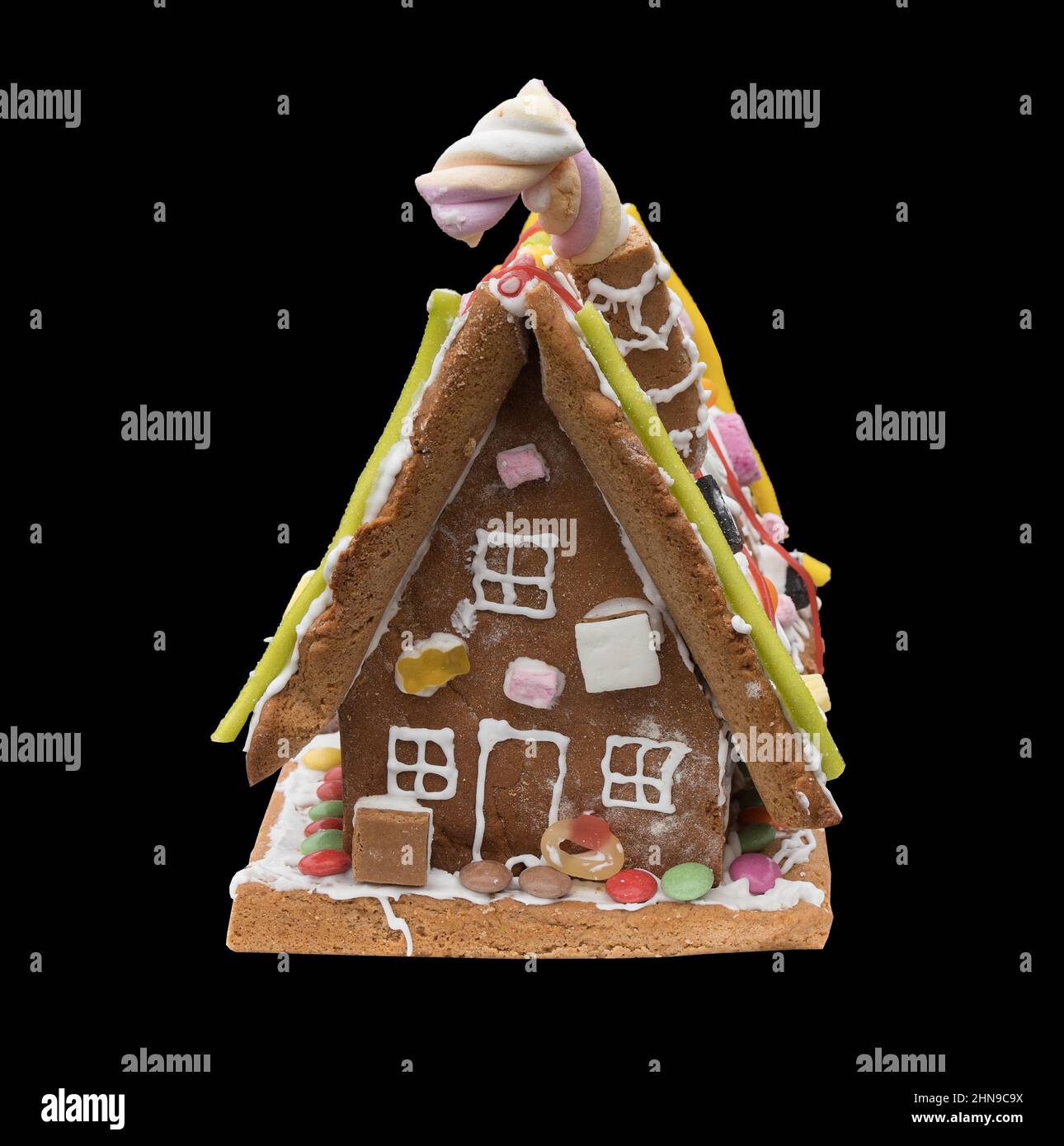 A Gingerbread house against a black background Stock Photo