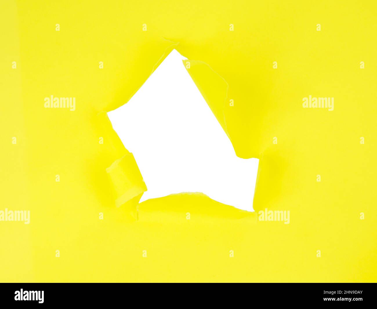 Yellow torn sheet of paper with whole space for text Stock Photo