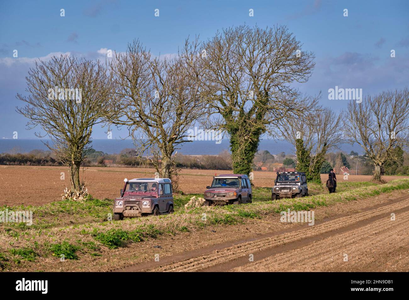 Land Rovers on a green lane near Wells-next-the-Sea with the North Sea in distance. Norfolk, England. Stock Photo