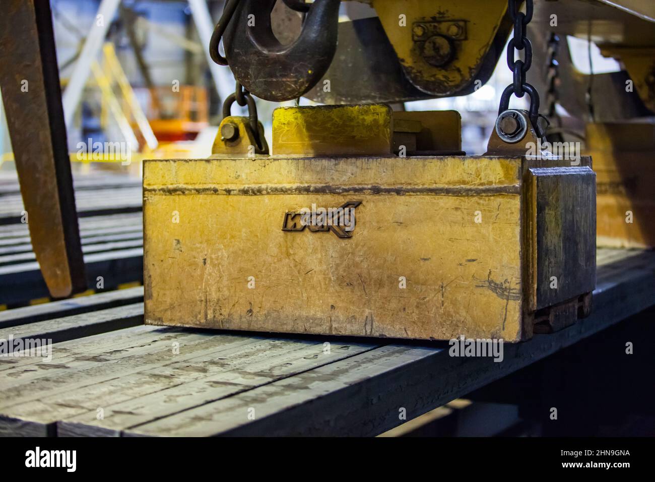 Temirtau, Kazakhstan - June 08, 2012: Arcelor Mittal metallurgy plant. Crane with lifting magnet WOKO for square bar metal. Close-up photo. Stock Photo