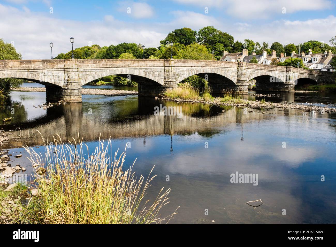 Old bridge (1813) reflected in River Cree in old burgh town in historical county of Wigtownshire. Newton Stewart Dumfries and Galloway Scotland UK Stock Photo