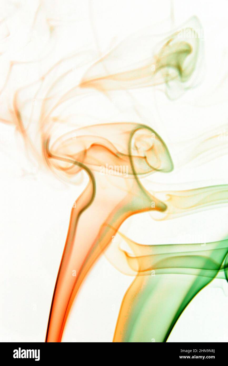 Real colorful smoke on white background. Graphic resource for use with blend modes. Fusion layers. Stock Photo